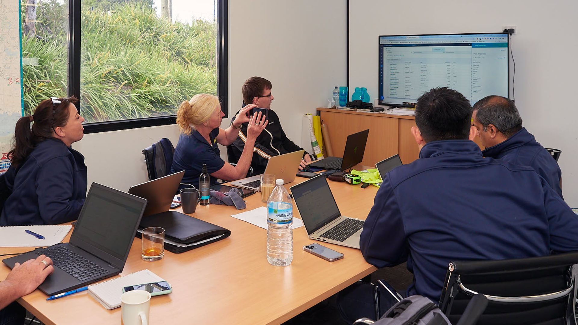 A team reviewing their sales system together on screen